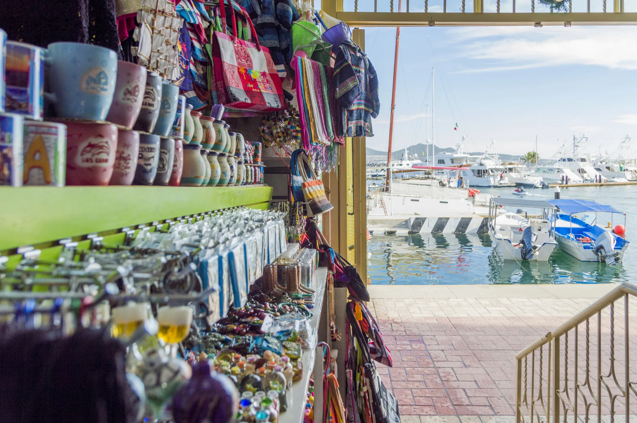 Market scene in Cabo San Lucas with stalls and pedestrians.