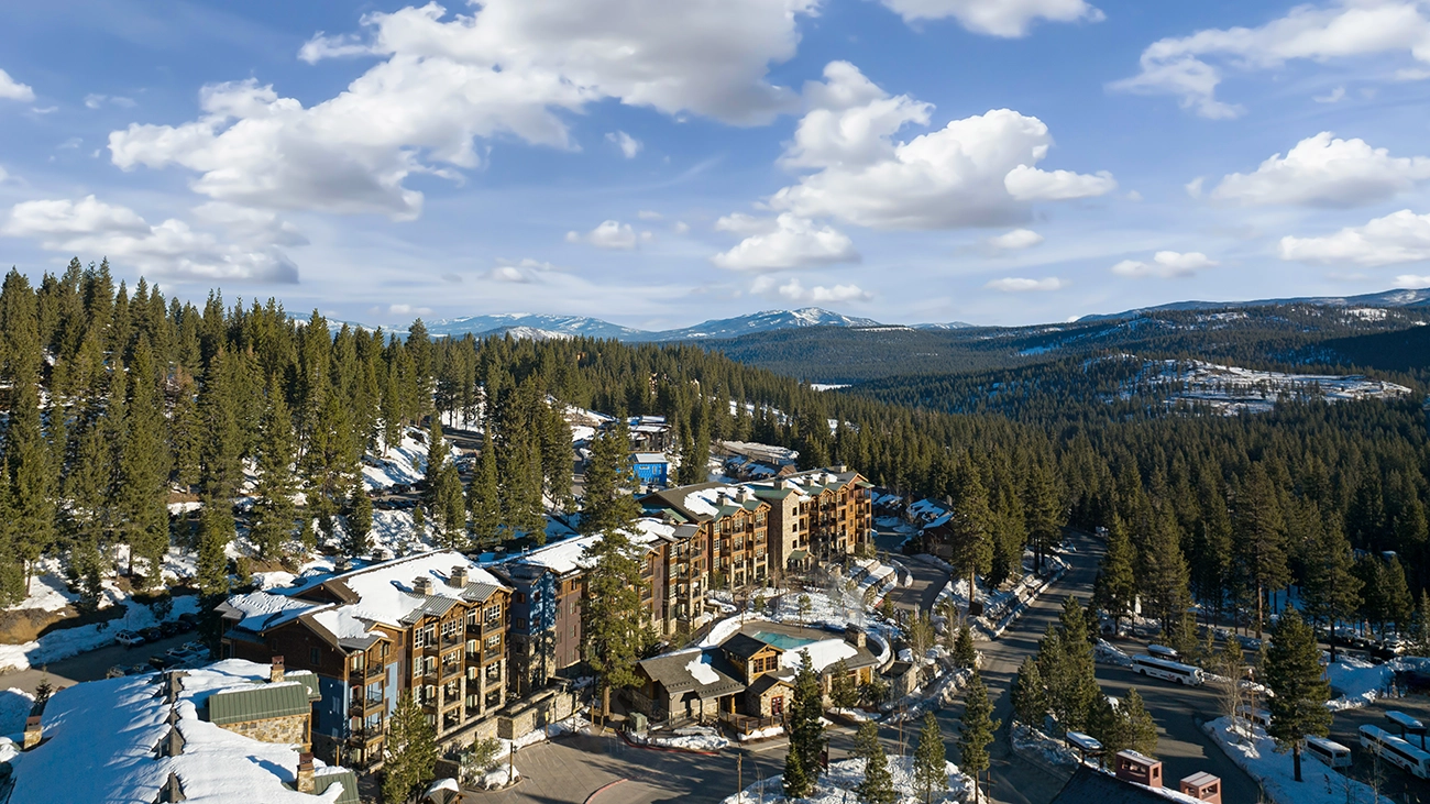 The snow-topped Northstar Lodge is surrounded by miles of trees