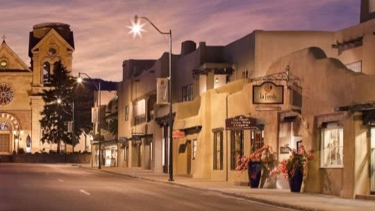 A quaint street with southwestern-style shops at dusk