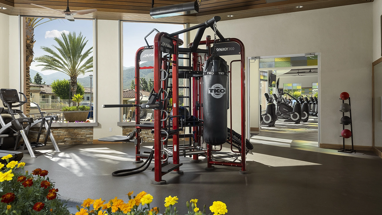 The fitness center with gym equipment and large windows
