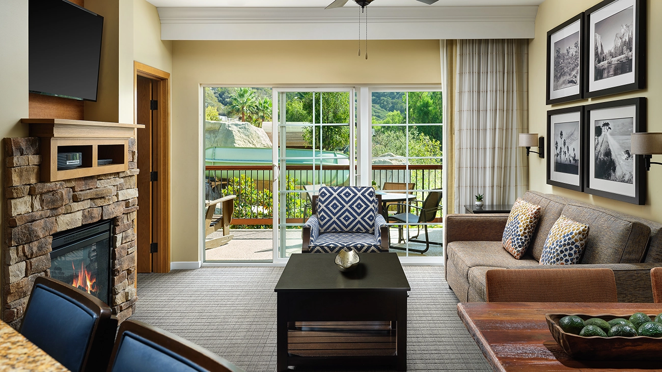 Living room with a fireplace, couch, and balcony